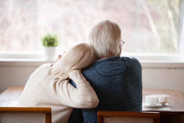 OLD-PEOPLE-COUPLE-WINDOW-shutterstock_1185179302