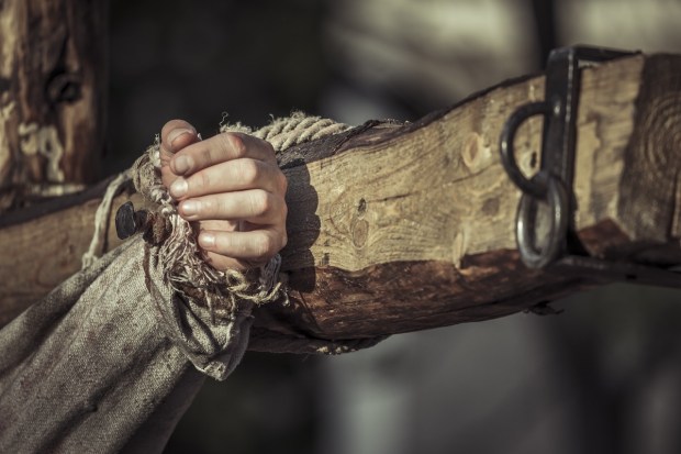 A hand nailed to a cross