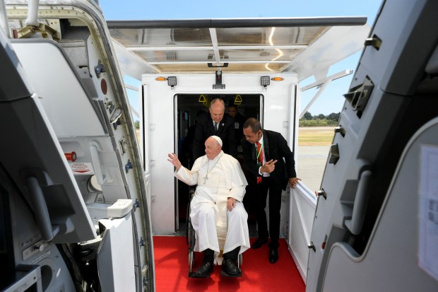 Pope Francis preparing to board a plane at Presidente Nicolau Lobato International Airport in Dili before departing for Singapore.