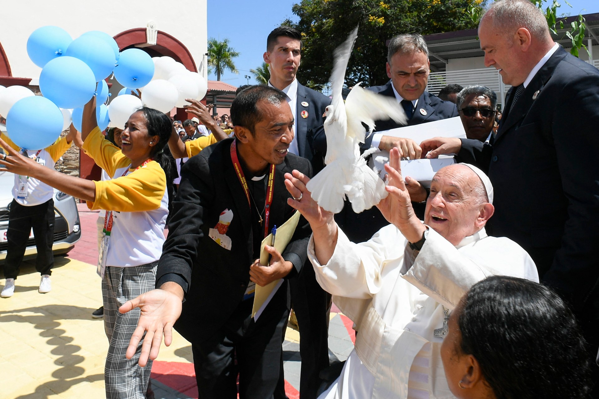 ased on September 11, 2024 by the Vatican Media shows Pope Francis (2nd R) releasing a dove as he arrives for meeting with young people at the Centro de Convercoies in Dili.
