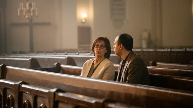 Portrait of Young Man and Old Woman Talking and Discussing While Sitting in a Church