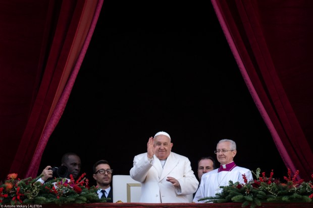 Pope Francis looks on from the main balcony of St. Peter's basilica after the Urbi et Orbi message and blessing to the city and the world as part of Christmas celebrations, at St Peter's square in the Vatican on December 25, 2024.