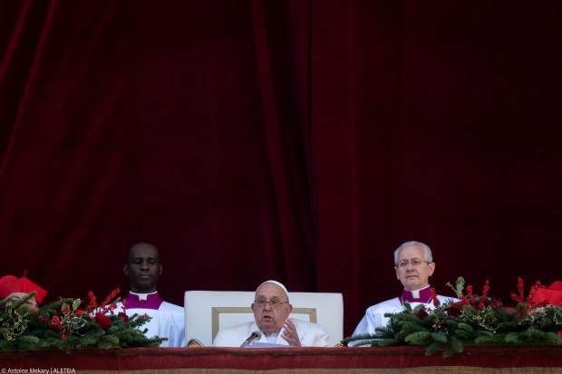 Pope Francis delivers the Urbi et Orbi message and blessing to the city and the world from the main balcony of St. Peter's basilica as part of Christmas celebrations, at St Peter's square in the Vatican on December 25, 2024.