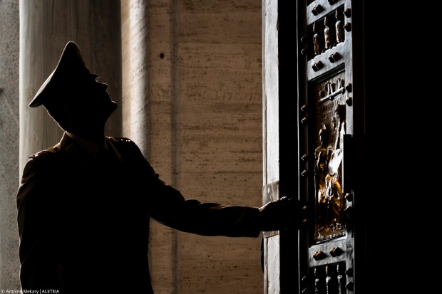 A member of the military touches St. Peter Basilica's holy door, on the occasion of Italian Armed Forces jubilee, at the Vatican, Saturday, Feb. 8, 2025.
